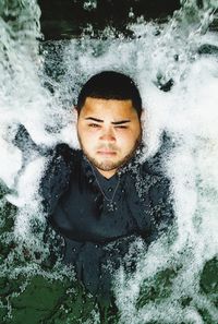 Portrait of young man in sea