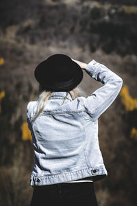 Rear view of woman wearing hat while standing outdoors