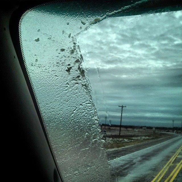 transportation, sky, mode of transport, road, cloud - sky, car, railroad track, land vehicle, street, cloudy, road marking, weather, power line, rail transportation, window, the way forward, glass - material, electricity pylon, no people, public transportation