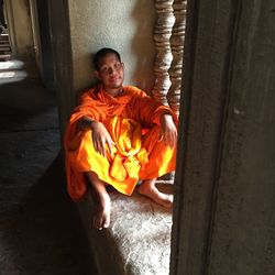 Portrait of young man standing by door