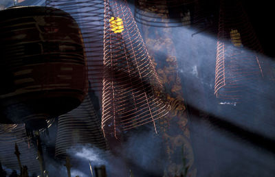 Low angle view of spiral incense sticks in temple