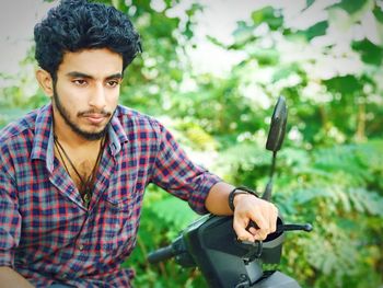 Young man sitting on motorcycle