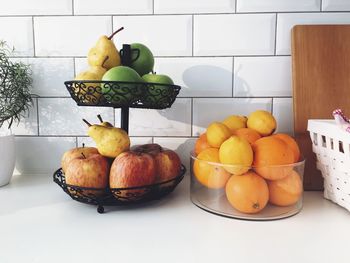 Fruits in containers on table in kitchen