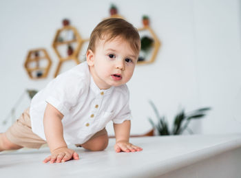 Portrait of happy funny child toddler boy interested looking at camera