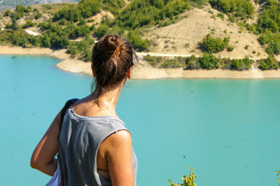 Rear view of woman looking at lake