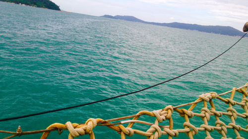 High angle view of rope at sea against mountain