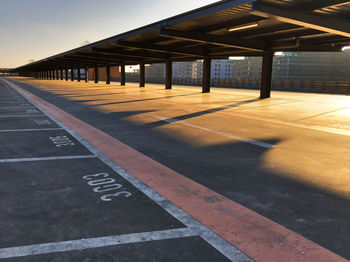 Empty road along built structures