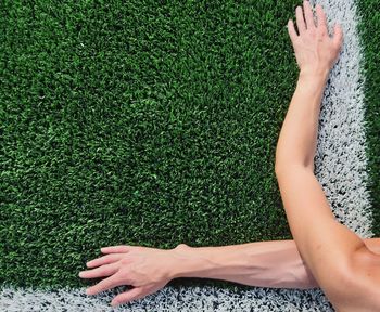 Low section of woman lying on grass