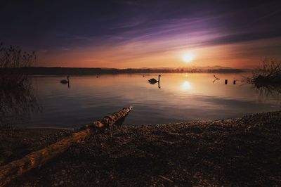 Scenic view of lake against sky during sunset