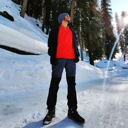 Full length of man standing on snow covered field