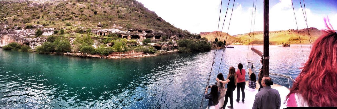 water, mountain, nautical vessel, boat, lifestyles, leisure activity, transportation, men, person, sky, lake, river, mode of transport, mountain range, large group of people, tree, nature, scenics, vacations