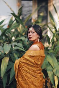 Portrait of young woman standing outdoors