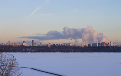 Scenic view of city against sky during winter