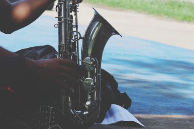 Midsection of man playing guitar