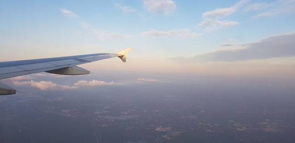 Aerial view of airplane flying in sky