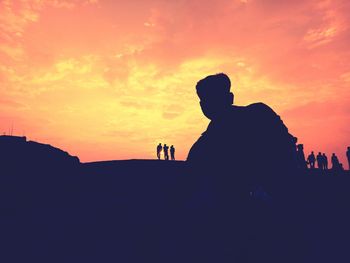 Silhouette people against sky during sunset