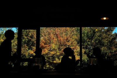 Silhouette of woman sitting in window