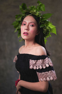 Portrait of a beautiful young woman standing outdoors