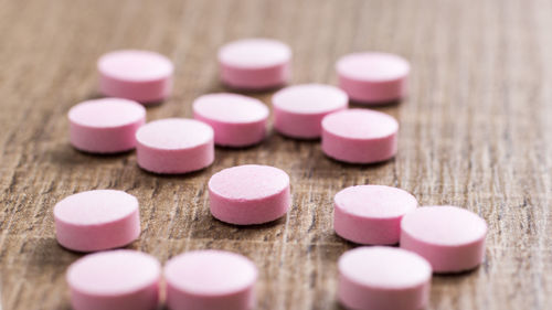 Close-up of pink medicines on table