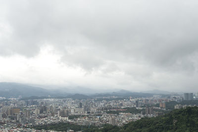 High angle view of city buildings against sky