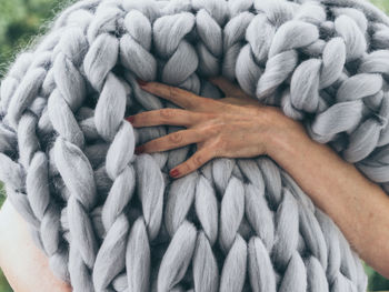 Cropped hand holding wool