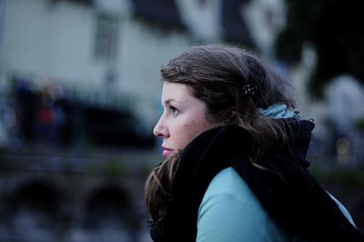 Close-up of woman looking away in city