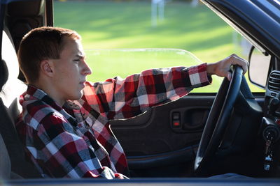 Boy sitting in car