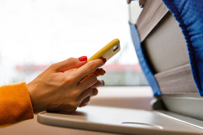 Close-up of hand holding mobile phone