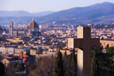 Cross against townscape