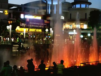 Crowd at illuminated city at night