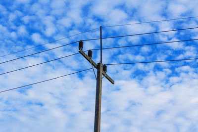 Low angle view of power line against sky