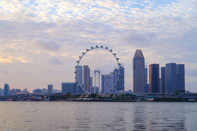 Singapore ferris wheel and business district and city, marina bay of singapore on february 2, 2020.