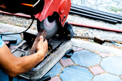 High angle view of man working on motorcycle