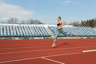 Full length of woman running on track