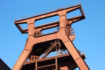 Low angle view of old building against clear blue sky