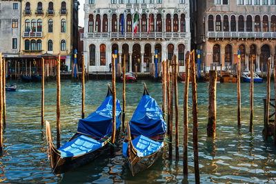 Sailboats moored in canal