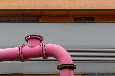 Close-up of fire hydrant against wall