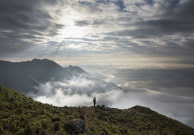 High angle view of man standing against cloudscape