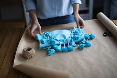 Handmade dress in paper packaging, the girl wraps the dress. concept of hobby and creativity
