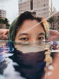 Close-up portrait of woman in swimming pool