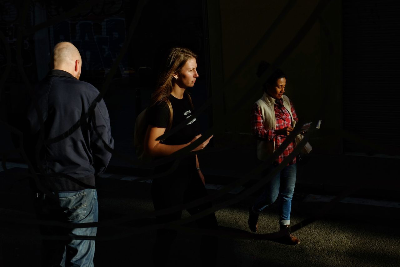 group of people, night, casual clothing, young adult, people, men, women, standing, togetherness, adult, young women, real people, young men, emotion, architecture, lifestyles, dark, full length, teenager, jeans, waiting