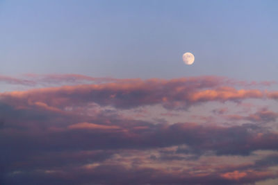 Low angle view of moon against sky at sunset
