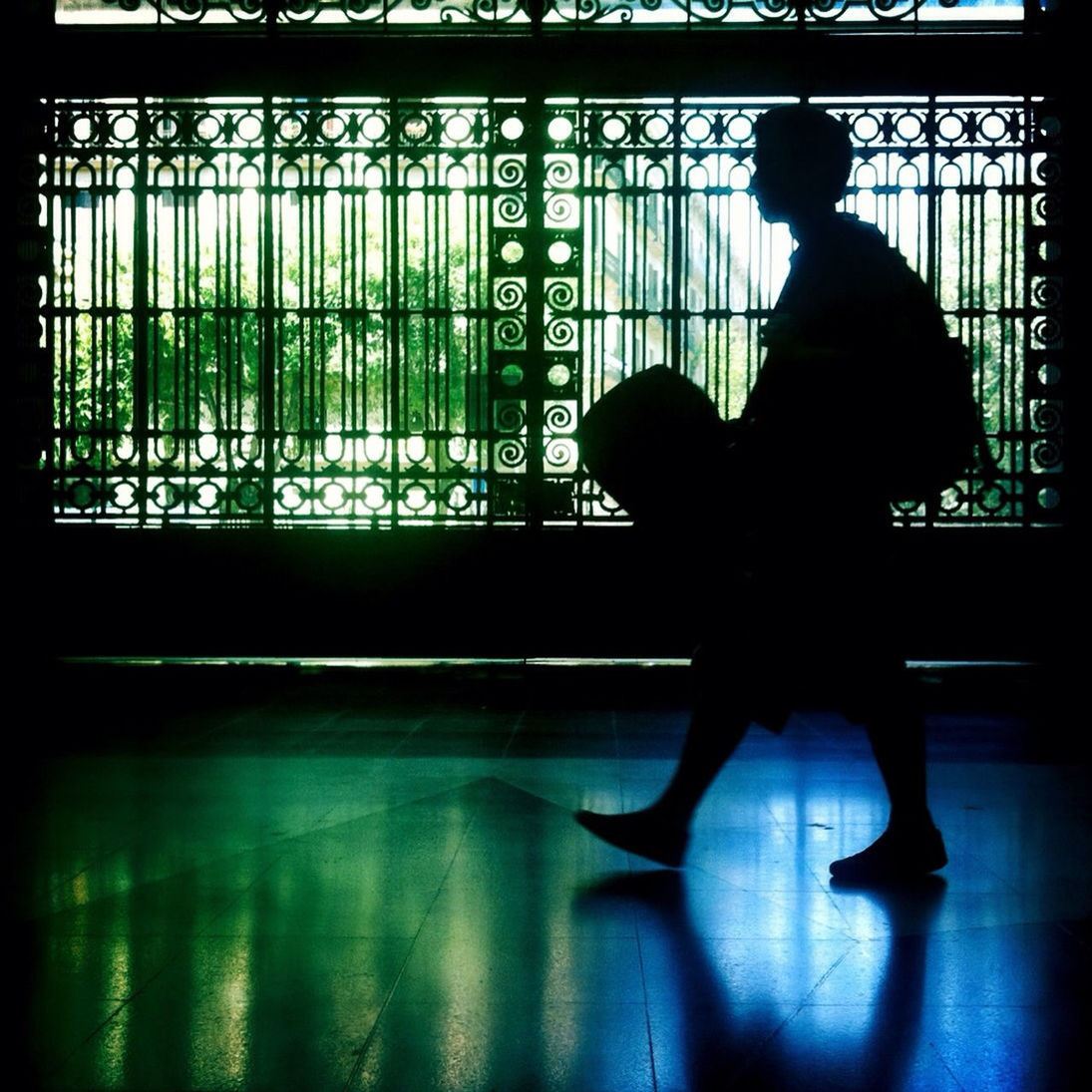 indoors, silhouette, window, glass - material, transparent, men, transfer print, lifestyles, rear view, standing, leisure activity, full length, built structure, auto post production filter, reflection, architecture, side view, looking through window