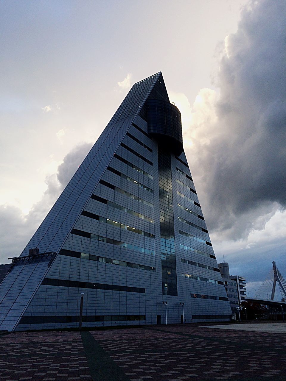 architecture, built structure, building exterior, sky, low angle view, cloud - sky, cloudy, cloud, city, tall - high, tower, outdoors, day, building, no people, sunlight, modern, development, overcast, tall