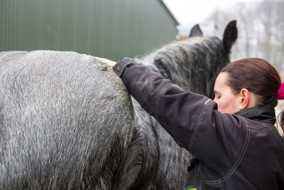 Rear view of man with horse