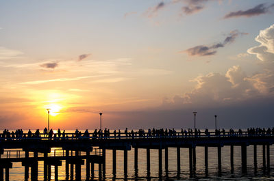 Silhouette pier on sea against sky during sunset