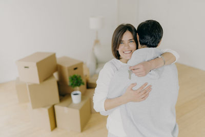 High angle view of couple embracing while standing at new home