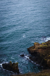 High angle view of rocks on sea