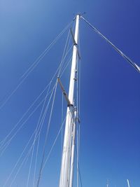 Low angle view of mast against clear blue sky