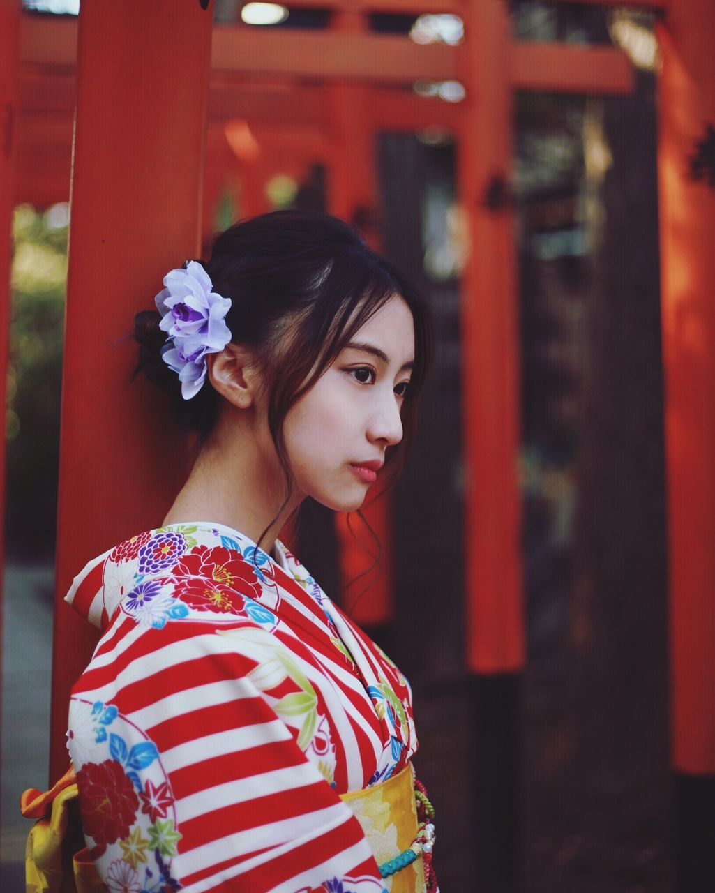 YOUNG WOMAN WITH RED FLOWERS